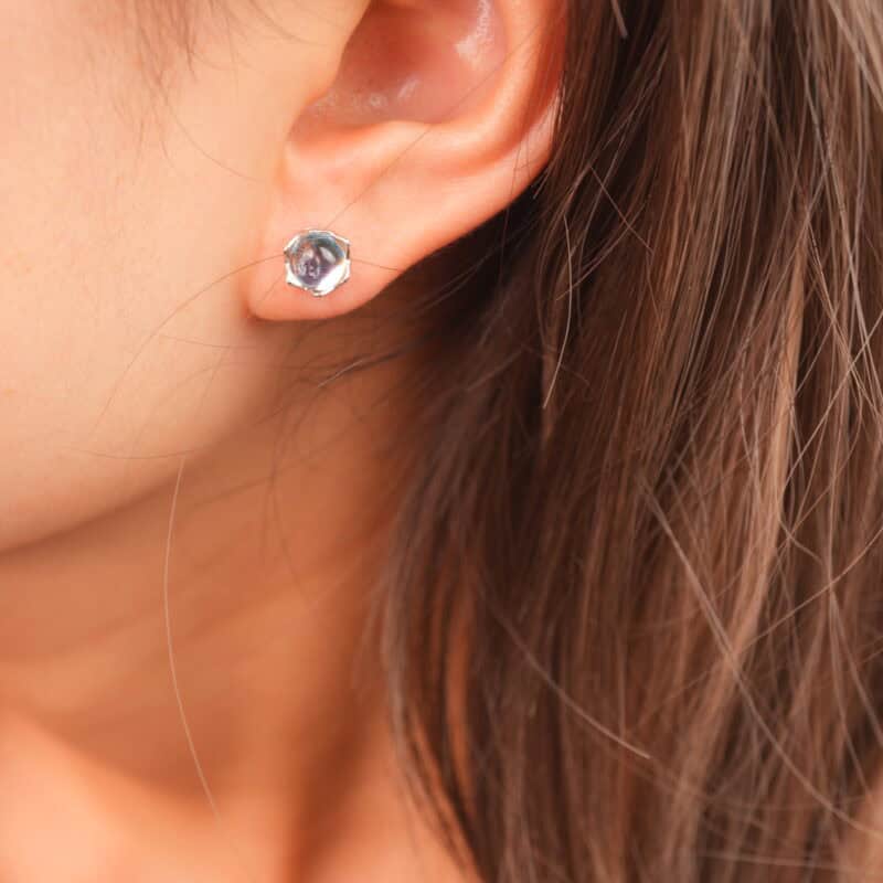 Model wearing the blue sheen moonstone studs, adding a touch of subtle elegance.
