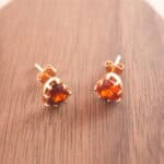 Close-up of the garnet heart studs showing the heart shape and natural gemstone luster.