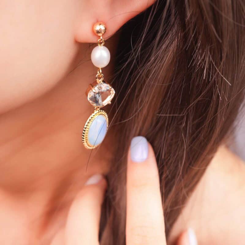 Model wearing the opal and pearl drop earrings, showcasing a soft and graceful look.