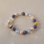 Elegant opal and pink chalcedony bracelet displayed on a neutral background.