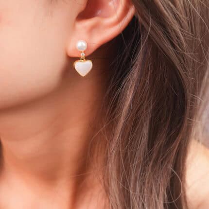 Model wearing the heart pearl earrings, showcasing a soft and sweet look.