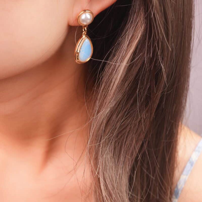 Model wearing the earrings, highlighting their elegant style and gentle luster.