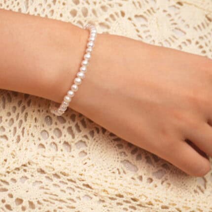 Model wearing the pearl stretch bracelet, showcasing elegant wrist lines and feminine charm.