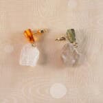 Close-up of the earrings showing the raw quartz texture and delicate craftsmanship.