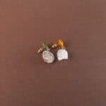 A pair of yellow-green chalcedony and raw quartz earrings displayed on a clean background, with a fresh and natural color tone.