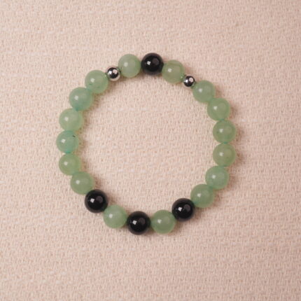 Green Aventurine and Obsidian bracelet, featuring smooth green aventurine beads and black obsidian beads, accented with silver spacers for an elegant design.