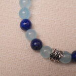 Close-up of the Aquamarine and Lapis Lazuli bracelet, highlighting the smooth textures and brilliant colors of the aquamarine and Lapis Lazuli beads with the silver spacer.