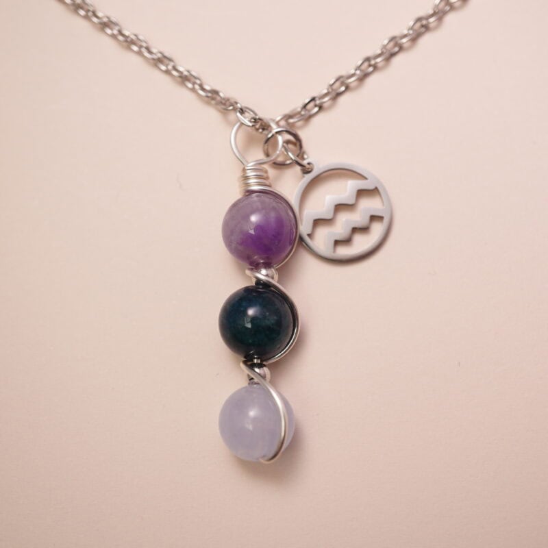 Aquarius zodiac necklace with amethyst, blue apatite, and aquamarine gemstones.