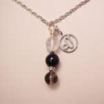 Capricorn zodiac necklace with clear quartz, obsidian, and smoky quartz gemstones.