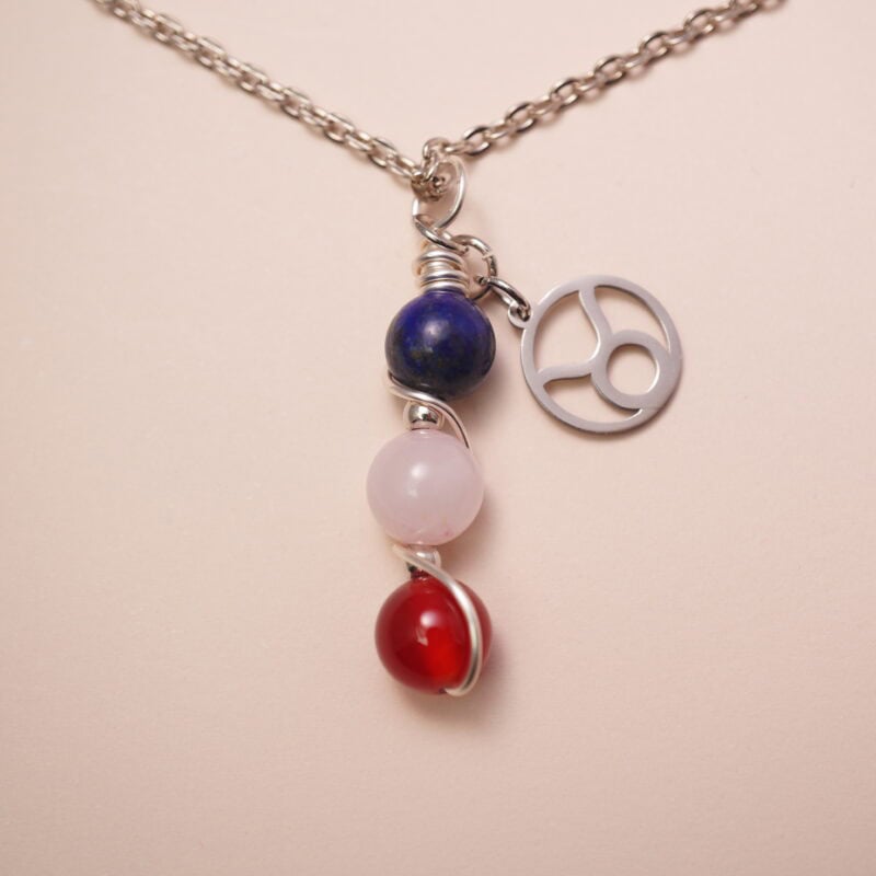 Taurus zodiac necklace with lapis lazuli, clear quartz, and red agate gemstones.
