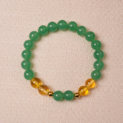 Green aventurine and citrine bracelet symbolizing wealth, good luck, and positive energy.