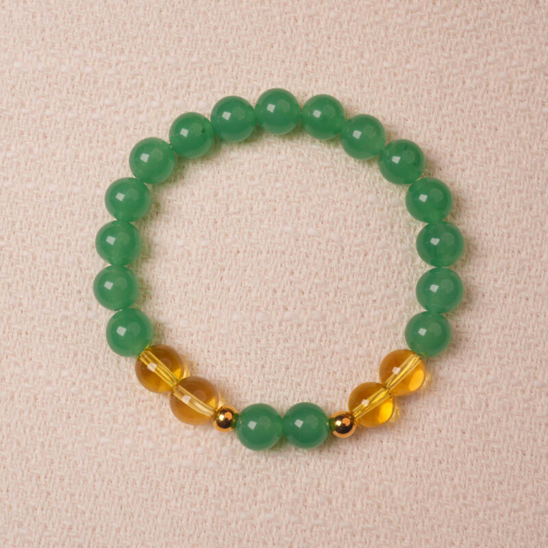 Green aventurine and citrine bracelet symbolizing wealth, good luck, and positive energy.