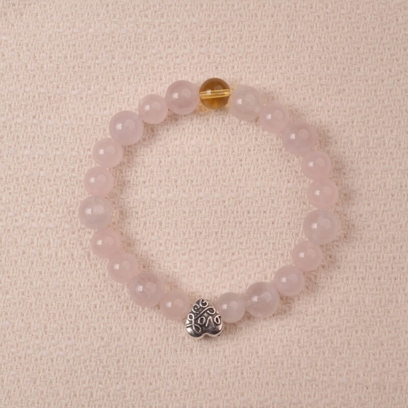 Rose quartz and citrine bracelet with silver heart charm, symbolizing love, happiness, and gentle energy.