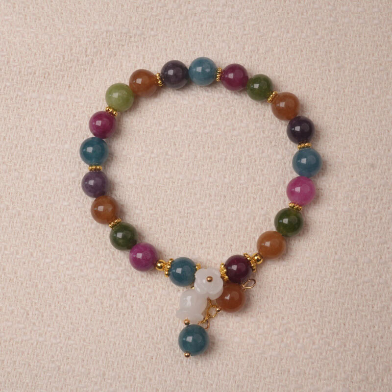 Multicolor tourmaline bracelet with white gourd charm, symbolizing protection, balance, and good luck energy.