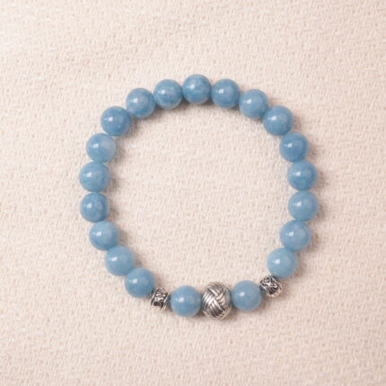 Aquamarine bracelet with silver accent beads, photographed under soft daylight to highlight the serene ocean-blue color and smooth gemstone finish.
