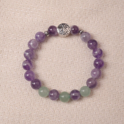 Amethyst and prehnite bracelet with a silver accent bead, photographed under soft daylight to highlight the calming purple and gentle green tones.