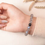 Back view of moonstone bracelet featuring soothing gray-blue shimmer for emotional balance.