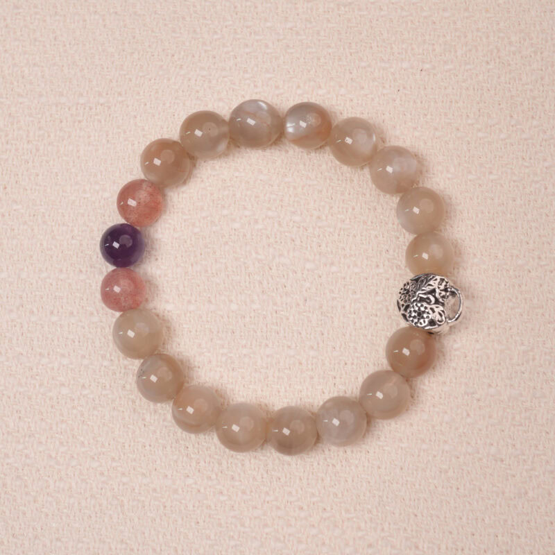 Moonstone, Amethyst, and Strawberry Quartz bracelet with a silver flower accent bead, designed for tranquility and emotional healing.