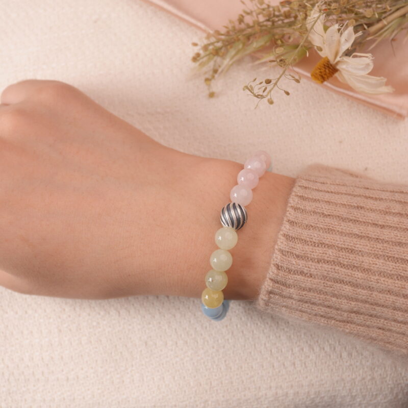 Model wearing Tranquil Harmony bracelet, showing a beautiful combination of soft pastel-colored beads.