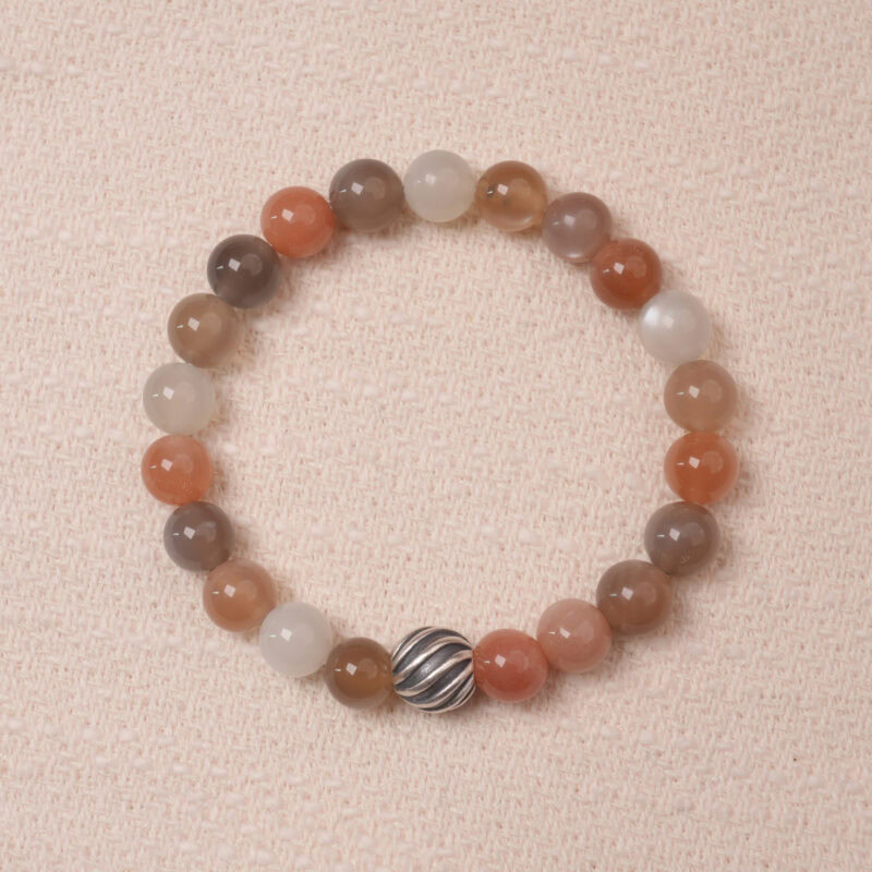 A stunning multicolor Moonstone bracelet with a variety of pastel hues, accented with a silver bead for added elegance. This bracelet combines soothing energy and the healing properties of Moonstone, making it perfect for balance and calm.