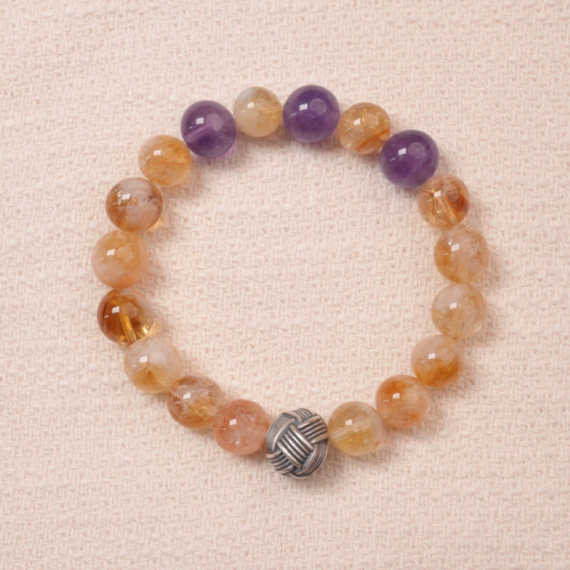 Citrine and amethyst bracelet featuring natural golden and purple beads, symbolizing wealth and wisdom.