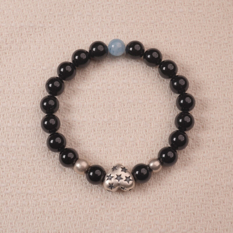 Black obsidian and aquamarine bracelet with a silver S925 heart charm, elegantly designed with shiny black beads and a subtle aquamarine centerpiece.