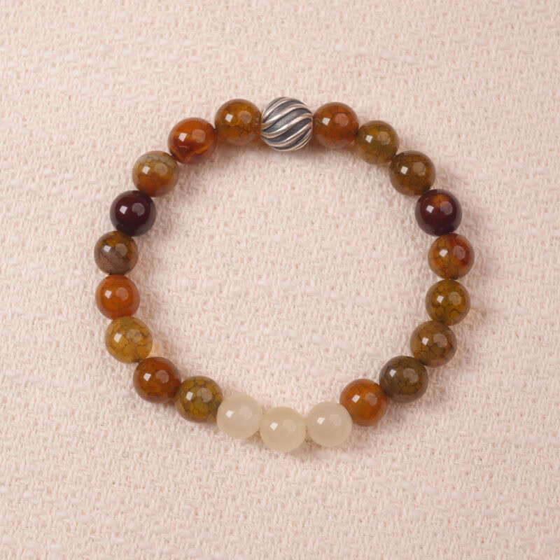 A close-up of a Yellow Chalcedony and White Chalcedony bracelet with smooth, polished beads in warm golden and soft white hues. The bracelet features a silver S925 spacer bead, adding elegance and contrast to the gemstones.