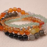 Close-up of the Solar Energy bracelet stack showing glowing tones and vibrant gemstone reflections.