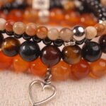 Detail shot of vitality gemstone bracelet with heart charm.