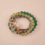 Multi-gemstone bracelet stack arranged flat, designed for good luck intentio