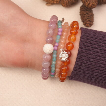 Sleep intention bracelet stack on wrist featuring lavender jade, rose-toned beads, and calming pastel stones.