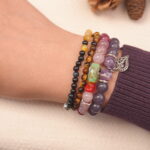 Side view of calming jade and agate bead bracelet stack worn on wrist.