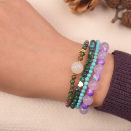 Calm intention multi gemstone bracelet stack on wrist with green, purple and blue chalcedony