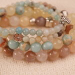 Close-up detail of calm intention bracelet stack with moonstone, amazonite and jade beads