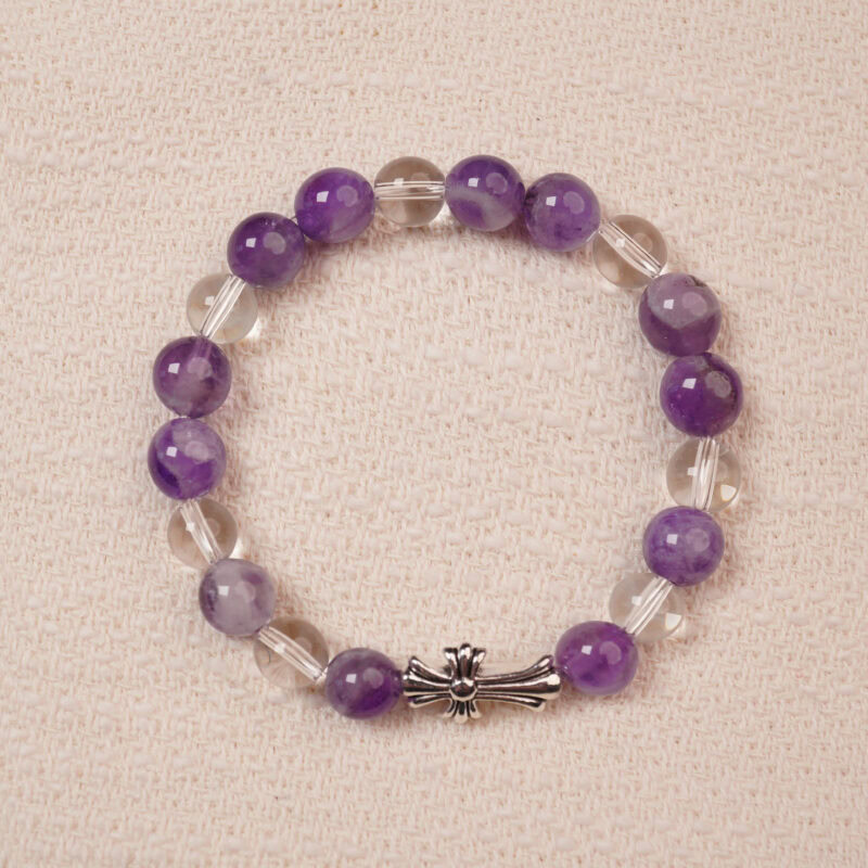 A beautiful bracelet featuring Amethyst and Clear Quartz beads, with a stylish silver cross accent. The smooth, vibrant purple amethyst is complemented by the transparent, calming clear quartz, making this piece perfect for adding balance and tranquility to your collection.