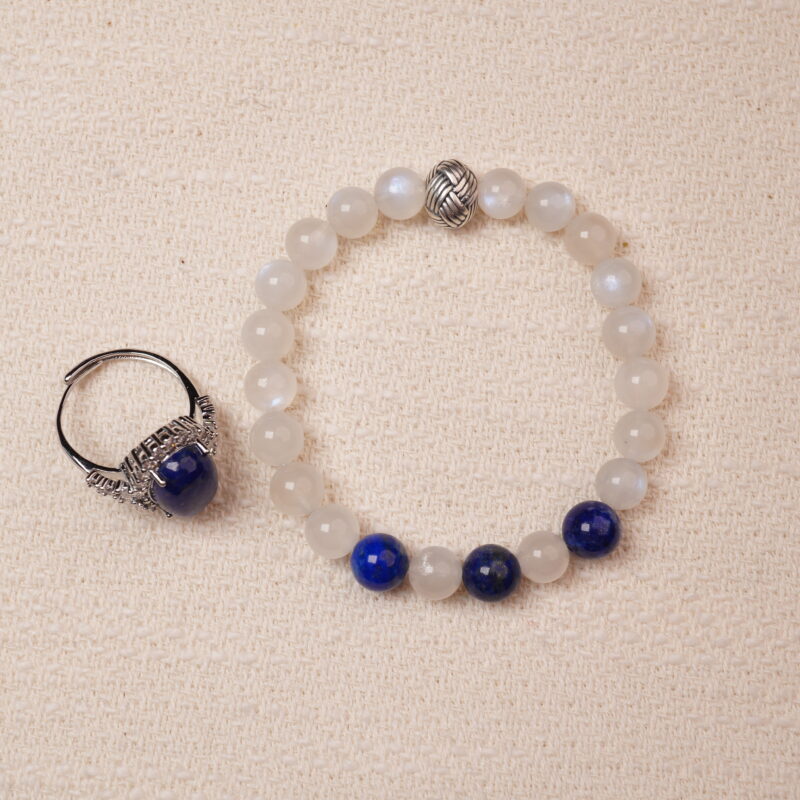 A stunning set featuring a Lapis Lazuli and Moonstone bracelet paired with a Lapis Lazuli ring. The bracelet combines smooth Moonstone beads with deep blue Lapis Lazuli, highlighted by intricate silver accents. The matching ring complements the bracelet with a bold Lapis Lazuli centerpiece encircled by sparkling details, creating a harmonious and elegant look.