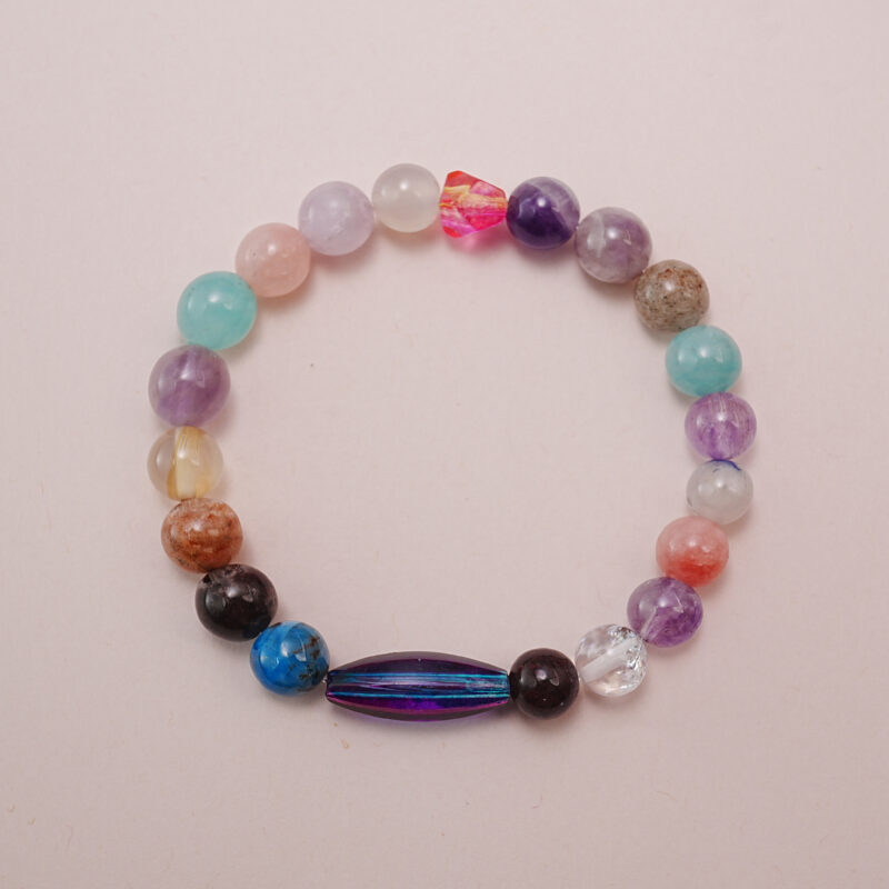Colorful multi-gemstone beaded bracelet featuring mixed natural stones such as amethyst, rose quartz, clear quartz, agate, aventurine, and blue sodalite.