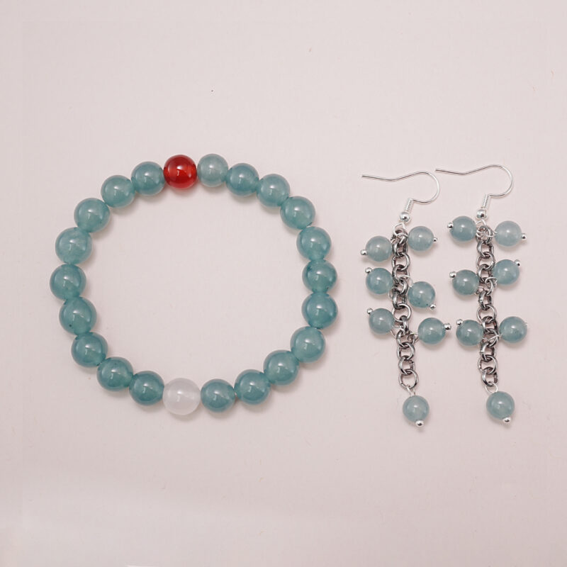 A beautiful set featuring a green chalcedony bracelet with a carnelian accent and matching green chalcedony earrings with a chain design.