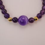 Close-up of the obsidian amethyst bracelet with golden beads and black obsidian accents
