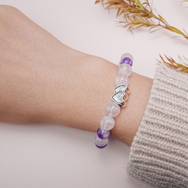 Amethyst and rose quartz heart bracelet worn on wrist – lifestyle view