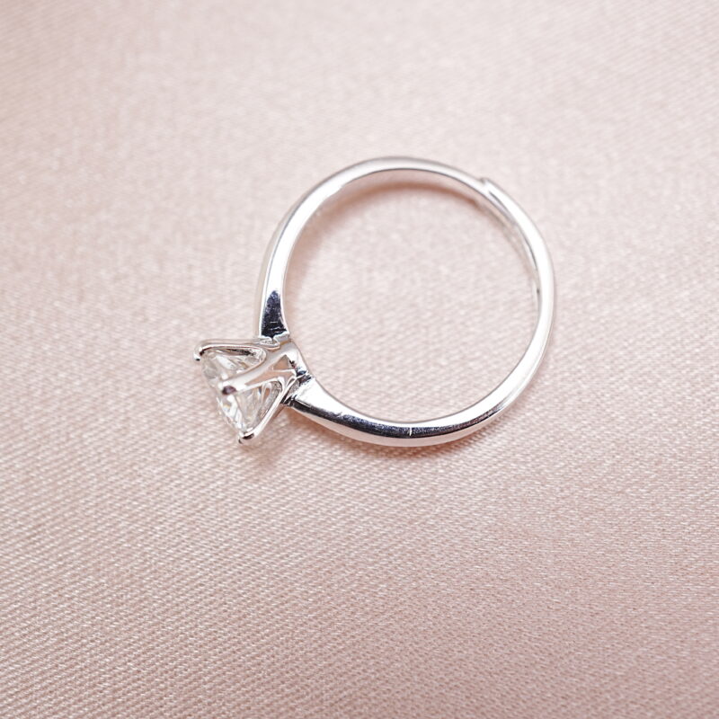 S925 moissanite solitaire ring displayed on soft pink background