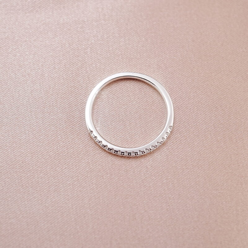 s925 sterling silver slim band ring with moissanite stones on pink background