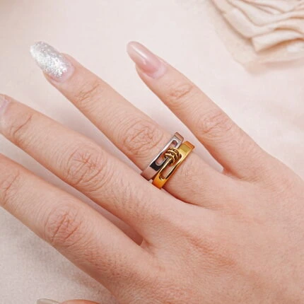 Model wearing two-tone stainless steel stacking rings in silver and gold