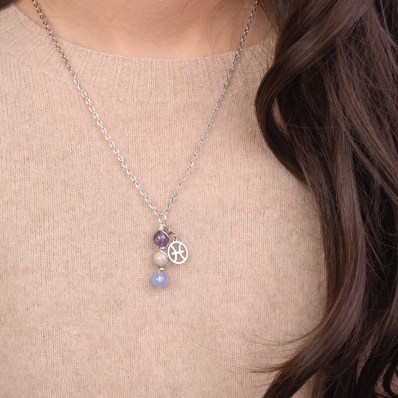 Model wearing Pisces zodiac necklace with amethyst, crazy agate, and aquamarine.