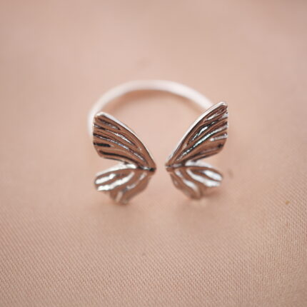 Silver butterfly wing adjustable ring featuring an open design symbolizing freedom and transformation.