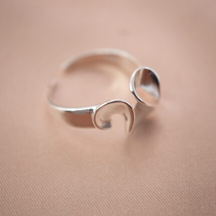 Silver open ring with petal-inspired design, symbolizing elegance and grace.