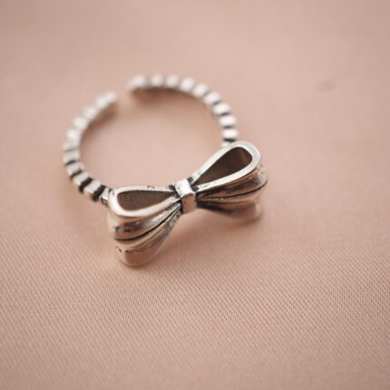 Vintage bow adjustable silver ring with a delicate ribbon design symbolizing grace and femininity.