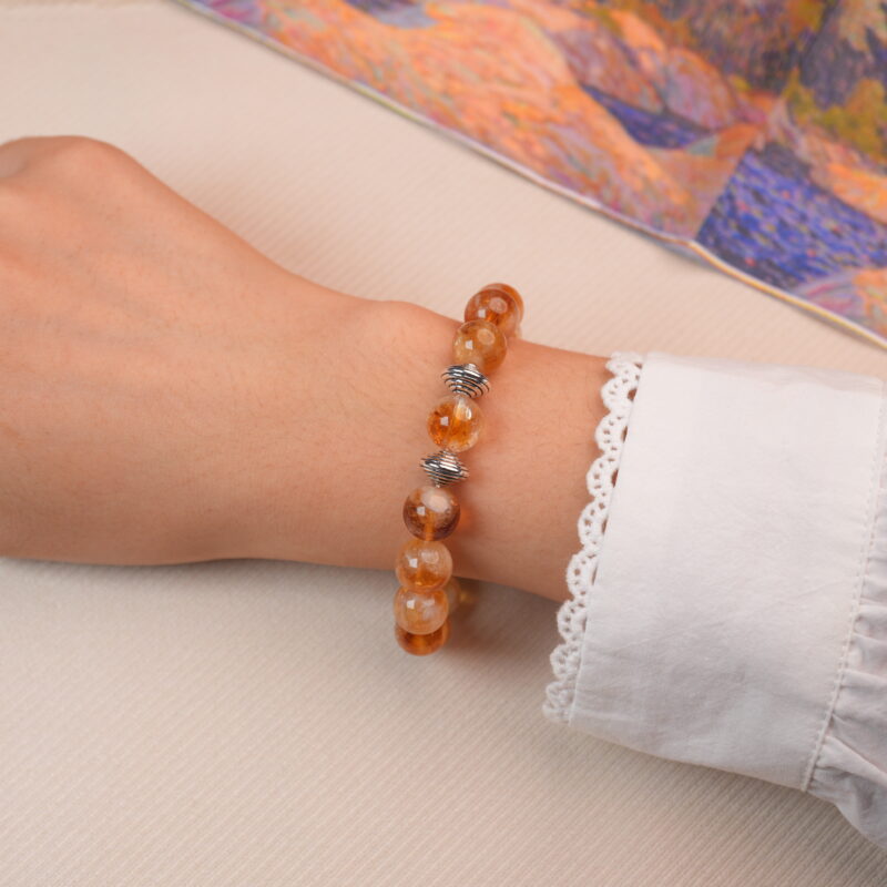 Model wearing citrine bracelet with silver spiral beads, showing a bright and uplifting look.