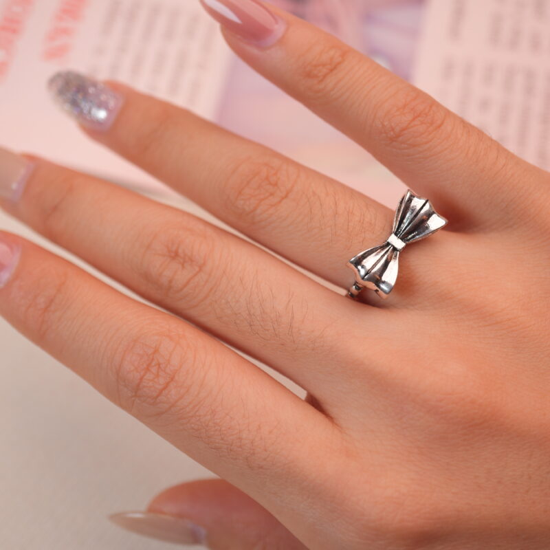 Model wearing the vintage bow silver ring, showing its cute and elegant feminine charm.