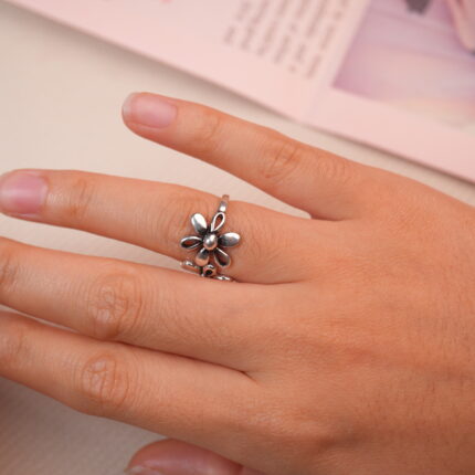 Model wearing the double daisy silver ring, showing its charming vintage floral look.